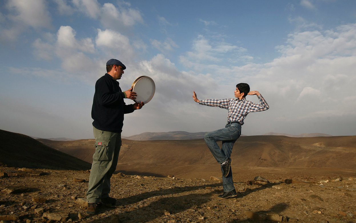 min Gholami, right, dances in Azeri-style as Aydin Kanani plays a Gaval, a large tambourine, in the Gharadagh mountainous area in northwestern, Iran, on October 26, 2011. In the 1980s, Iran's music almost vanished. Music schools went into full recession, police or militias stopped cars to check what passengers were listening to and broke tapes playing pre-revolutionary singers, and clerical institutions even banned music as un-Islamic. But Iran's social life has dramatically changed a decade later, with a landslide victory of former President Mohammad Khatami relaxing some of rigid restrictions on cultural and social activities, including bans on music bands, but Iran has recently tightened censorship of books, films, and music since President Mahmoud Ahmadinejad came to power. (AP Photo) #