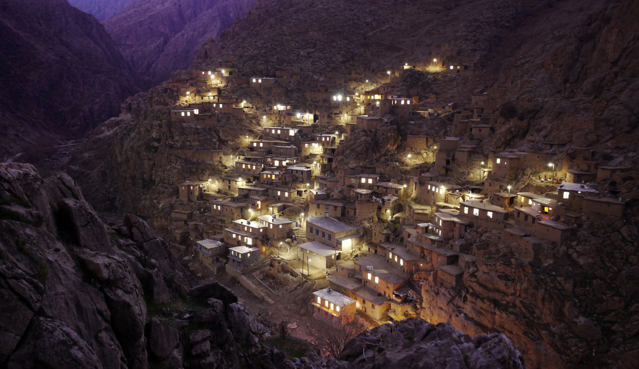  Palangan Village, in the mountains near the Iraq border. Palangan, illustrative of many of the country's rural settlements, has benefited handsomely from government support. Many villagers are employed in a nearby fish farm, or are paid members of the Basij, whose remit includes prevention of "westoxification", and the preservation of everything the 1979 Islamic revolution and its leader the Ayatollah Khomeini stood for, including strict rules on female clothing and male/female interaction. (© Amos Chapple)